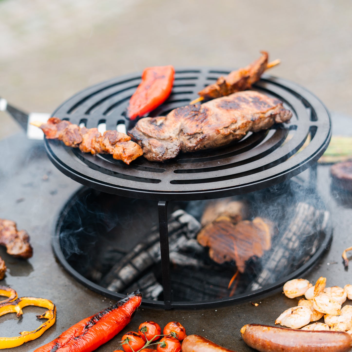 BBQ Plancha Grill Compañero XXL Acero Corten 2.0 - Con atizador y almacén de leña Ø80cm