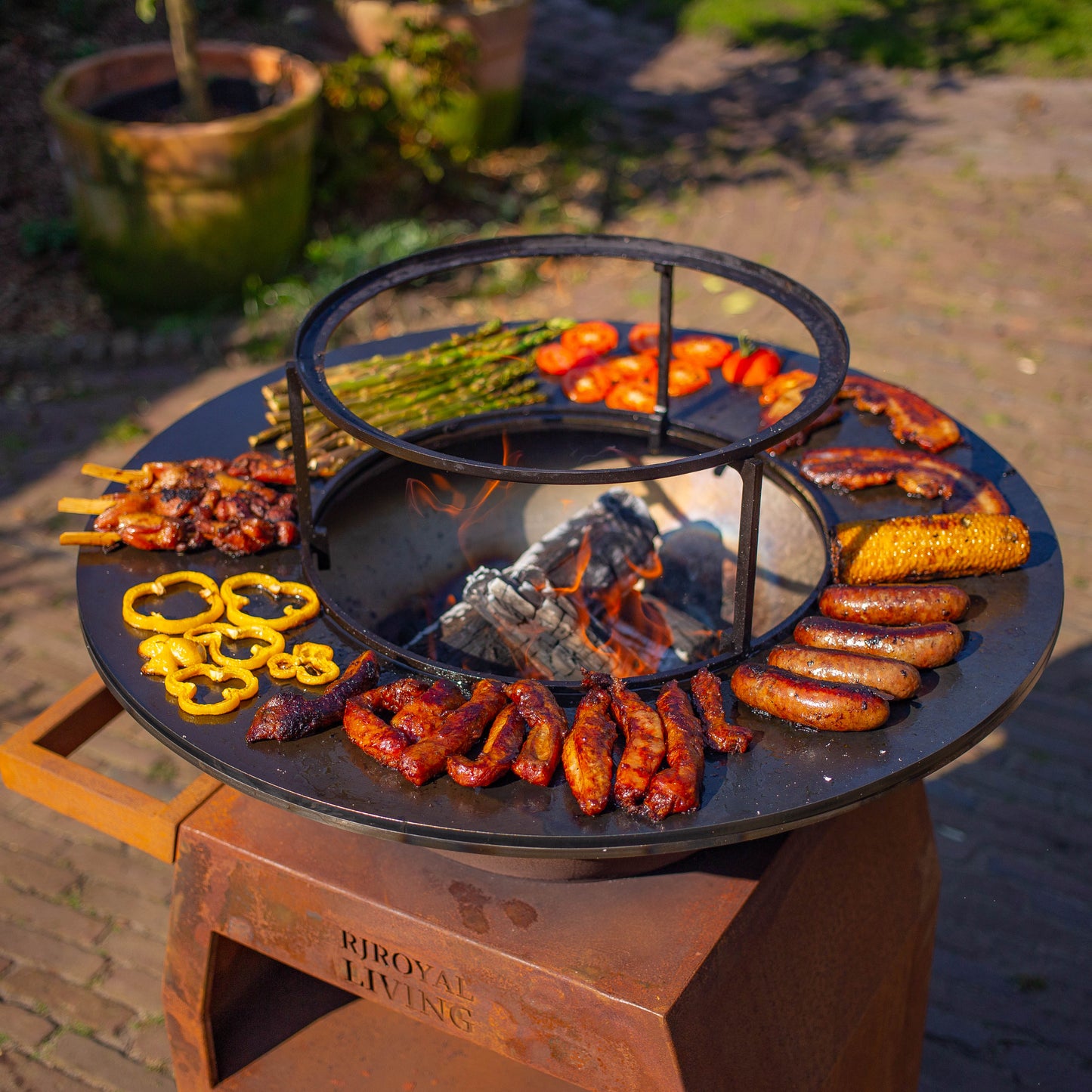 BBQ Plancha Grill Maestro Ø70cm Acero Corten - Con ruedas grandes y almacenamiento de leña