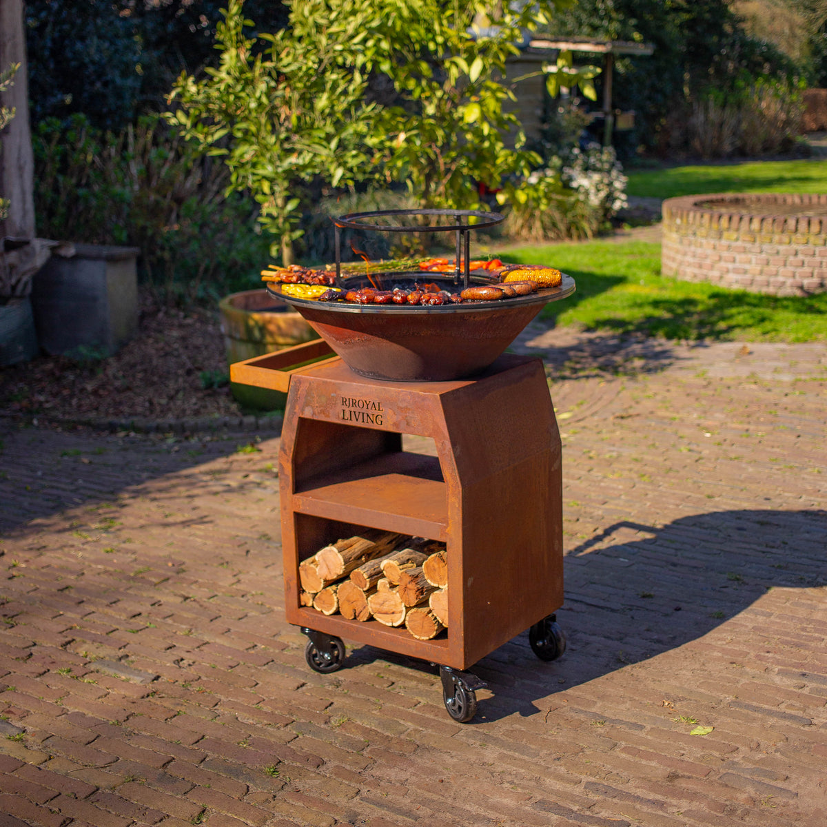 BBQ Plancha Grill Maestro Ø70cm Acero Corten - Con ruedas grandes y almacenamiento de leña